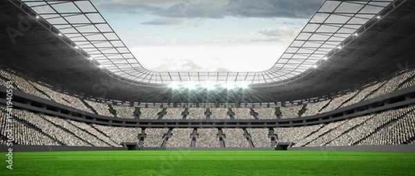 Fototapeta Flat green grass football pitch is extending under roof canopy with floodlights against cloudy sky