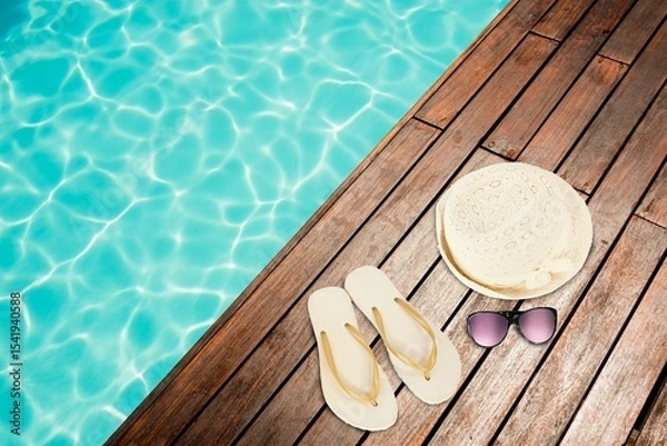 Obraz Hat and flip-flop with sunglasses by swimming pool