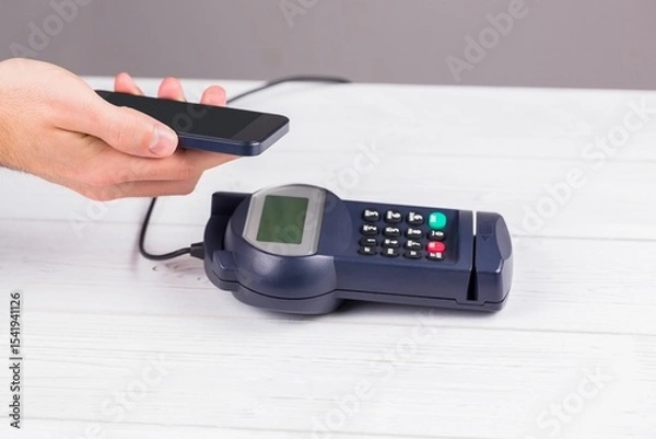 Obraz Man using smartphone to express pay