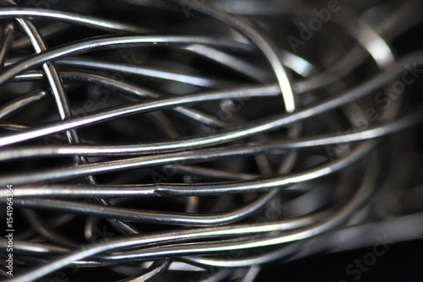 Fototapeta Woven Metal Texture: Capturing the intricate patterns and textures of intertwined metal wires, creating a sense of industrial detail.