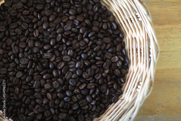 Fototapeta Roasted Coffee Bean Harvest: A full basket of freshly roasted coffee beans, each a dark treasure, overflows, promising the rich aroma and satisfying taste of the world's favorite beverage.