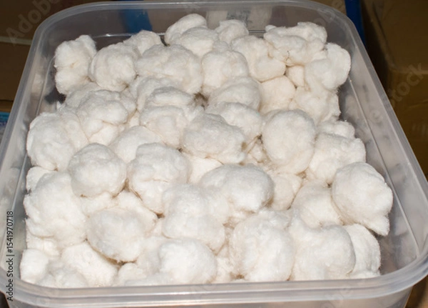 Obraz sterilized white cotton balls neatly stored in a clean, transparent box, commonly used in hospitals, clinics, and medical setups. essential medical supplies for wound care, injections.