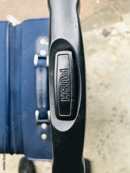 Obraz Travel suitcase with push handle for easy mobility in transit