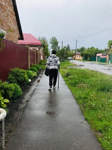 Obraz Active elderly person with disability enjoying a walk outdoors