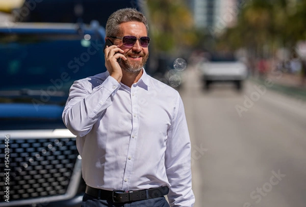 Obraz Business call. Man phone conversation. Mature Hispanic business man with phone. Entrepreneurial mindset. Negotiation online. Business man talking on phone outdoor. Businessman using phone