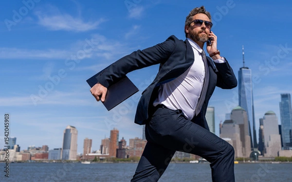 Obraz Businessman running to success. Business success. Successful businessman hurrying on New York city skyline. Business man in Manhattan. Business success in big city. Advertisement
