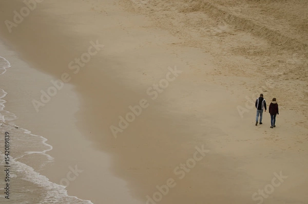 Obraz Couple walking on the beach. Cat Co 3 Beach. Cat Ba Island. Cat Ba Archipelago. Vietnam.