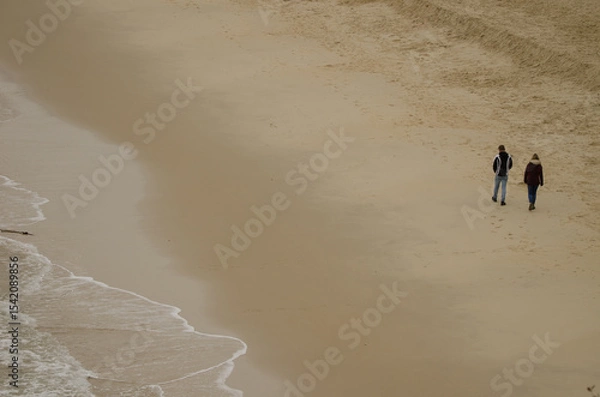 Obraz Couple walking on the beach. Cat Co 3 Beach. Cat Ba Island. Cat Ba Archipelago. Vietnam.