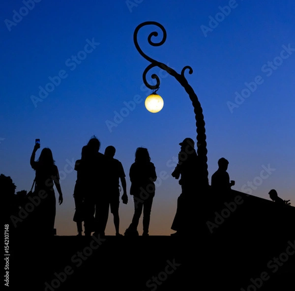 Obraz Black silhouettes of people on the horizon at sunset on a viewpoint
