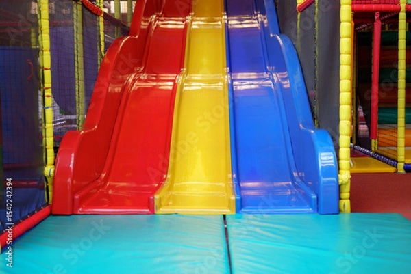 Obraz Brightly colored slides in a children's indoor play area invite fun and excitement for kids of all ages