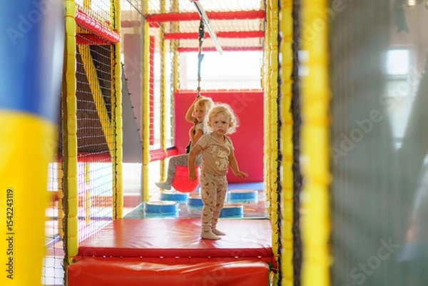 Obraz Children playing and exploring in an indoor play area designed for adventure and fun in bright colors and safe environment