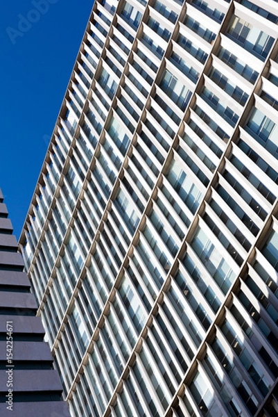 Obraz Modern building facade with repetitive architectural elements reaching for the sky