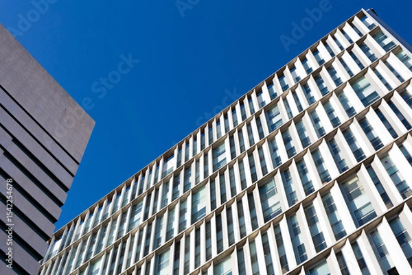 Obraz Modern building facade with repetitive architectural elements reaching for the sky
