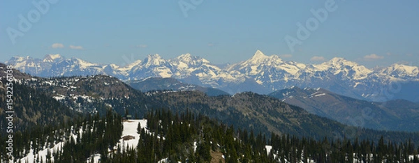 Fototapeta Breathtaking view of snow capped mountain range from Montana ski resort