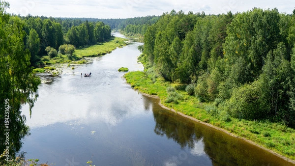 Fototapeta Rafting on Chusovaya river against background of coniferous trees and greenery on sunny summer day, Ural, Sverdlovsk region, Russia