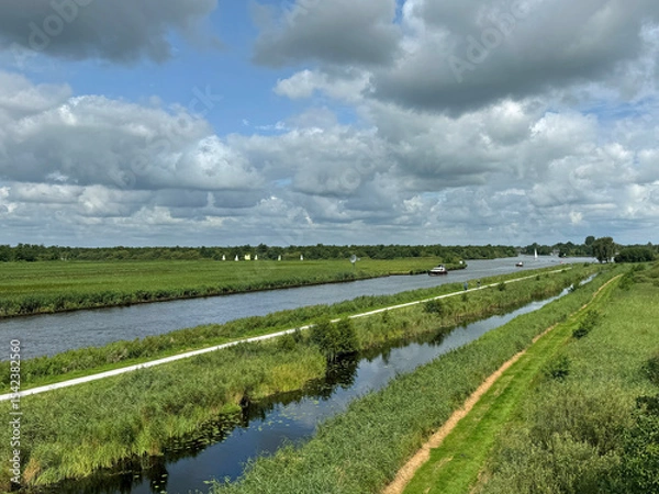 Obraz Typical Dutch canal with a partly cloudy sky.