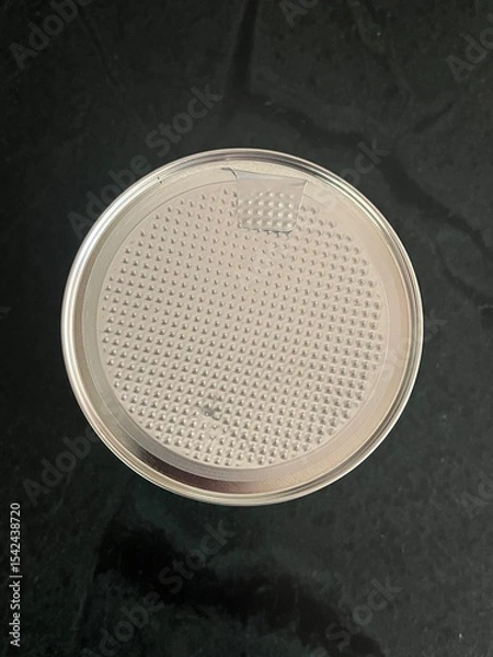 Fototapeta Metal lid on peanuts