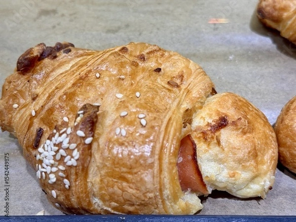 Obraz A delightful stack of warm, freshly baked, golden croissants is beautifully arranged. An enticing tower of perfectly baked golden croissants, showcasing their flaky and delightful texture beautifully