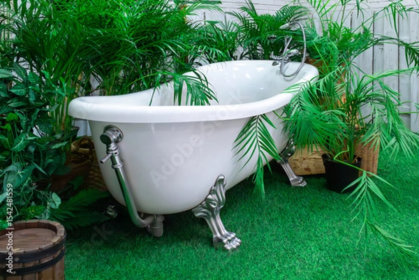 Fototapeta Relaxing vintage bathtub surrounded by lush greenery in a serene garden setting