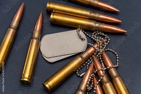 Obraz Close-up of ammunition and two metal army badges. The composition conveys the themes of the armed forces and veterans.