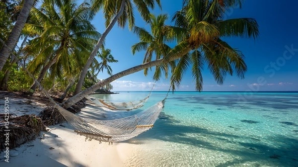 Obraz Tropical beach with palm trees reflected in crystal-clear water White sand, turquoise sea, cloudless blue sky, two hammocks between palm trees