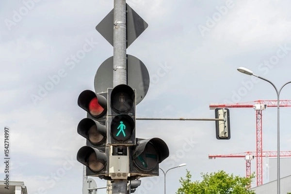 Obraz Pedestrian green and vehicle red traffic lights under sunny conditions