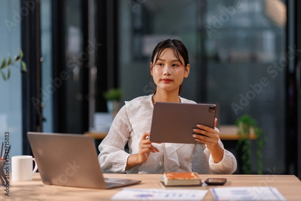 Obraz accounting concept. businesswoman working using tablet laptop with analyzing finance sales data and economic growth graph chart. at the home office.	 
