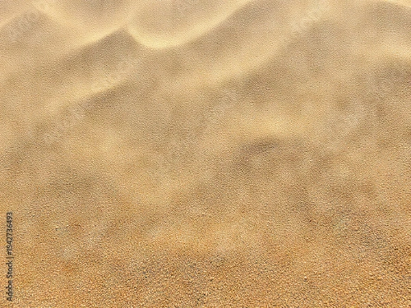 Fototapeta Golden sand texture with soft ripples, evoking serene desert or beach atmosphere