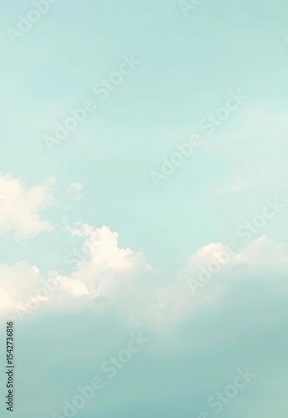 Fototapeta Soft pastel blue sky with fluffy white clouds creating serene and tranquil atmosphere