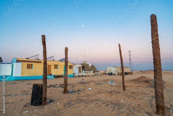 Obraz This image captures abandoned homes in the desert near Aswan, Egypt, at dawn. The serene sky and desolate landscape create a striking contrast, highlighting the beauty and isolation of the area.