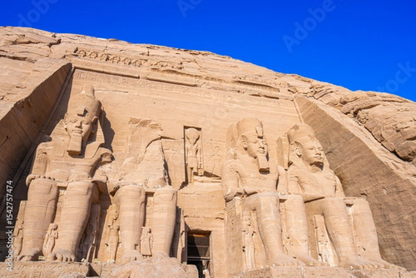 Obraz Close up of the majestic Great Temple of Ramses II at Abu Simbel, Aswan, Egypt. The colossal seated statues of Pharaoh Ramses II dominate this iconic ancient Egyptian monument.