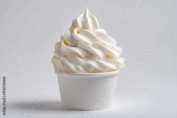 Fototapeta Creamy soft serve ice cream in a white cup against a plain background.