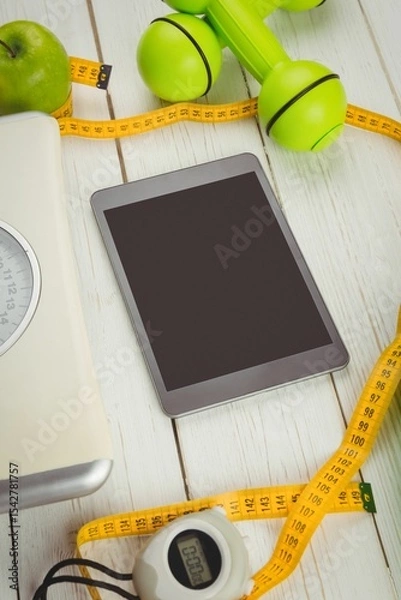 Obraz High angle view of digital tablet and tape measure