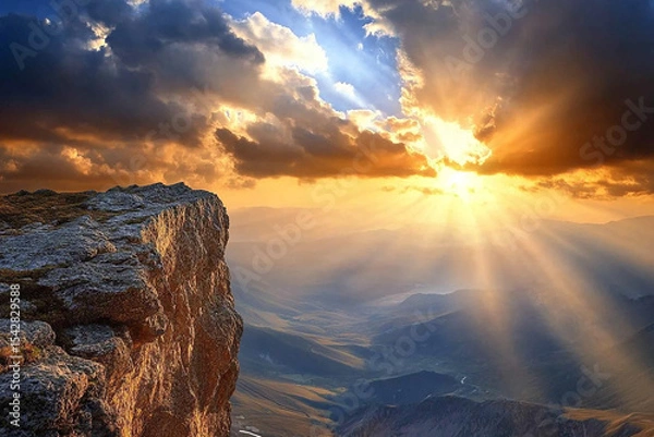 Obraz Cliffside view of mountains and valley with sun rays piercing through clouds