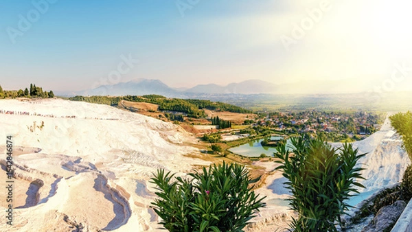 Fototapeta Panoramic view of the stunning white travertine terraces and thermal pools of Pamukkale, a famous UNESCO World Heritage Site and popular tourist travel destination in Denizli, Turkey