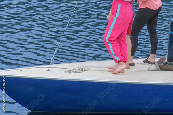 Fototapeta Having bare feet while sailing on a yacht