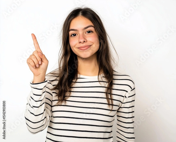 Fototapeta Smiling Woman in Striped Shirt Pointing Up – Studio Portrait with White Background, Perfect for Advertising, Branding, or Marketing Campaigns