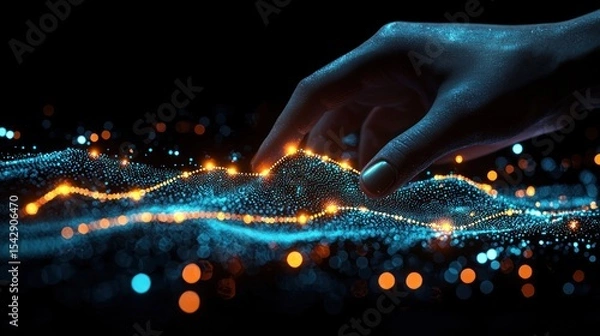 Obraz A hand interacts with a digital landscape of glowing particles.