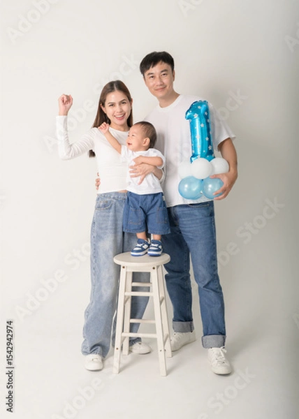 Fototapeta Family Poses Together in a Studio Portrait With Joyful Smiles and Playful Atmosphere