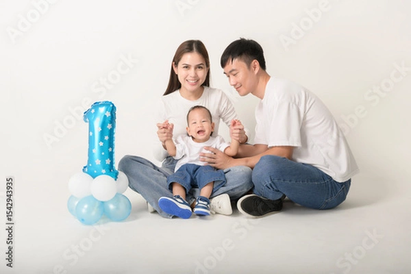 Fototapeta Family Poses Together in a Studio Portrait With Joyful Smiles and Playful Atmosphere
