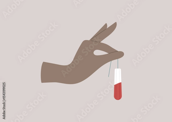 Obraz A hand delicately holds a tampon soaked with blood, symbolizing the importance of hygiene in a monthly menstrual cycle