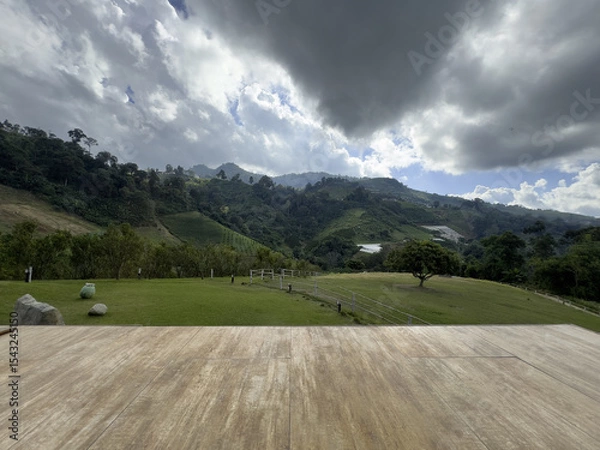 Fototapeta Wooden Deck with Scenic Mountain View Under Cloudy Sky