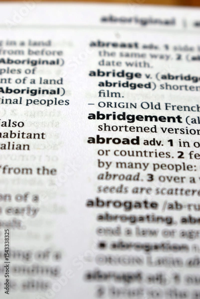 Fototapeta Close Up Of English Dictionary Page With Word - Abridgement