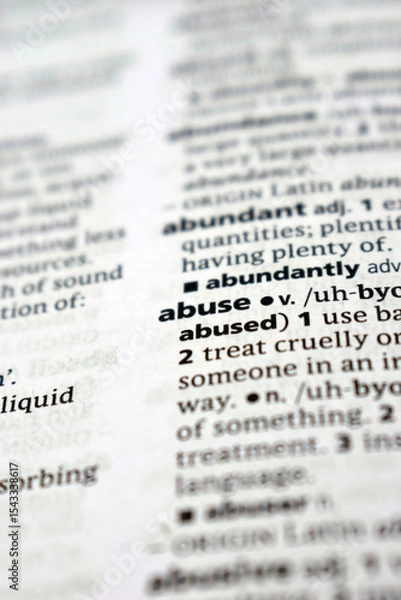 Fototapeta Close Up Of English Dictionary Page With Word - Abuse