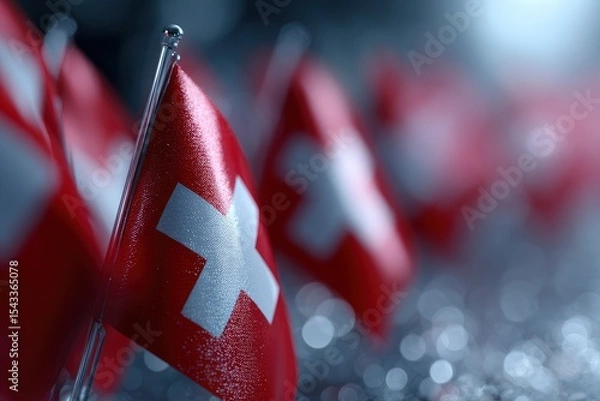 Fototapeta Multiple Swiss flags on silver stands with a bokeh background
