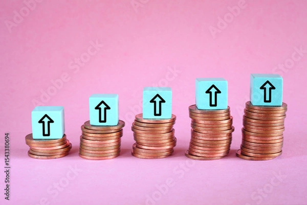 Obraz Business concept for financial growth, interest rate increase, inflation, high price, tax and tariffs rise . Arrow up sign on wooden cube blocks above stack of coins, free copy space

