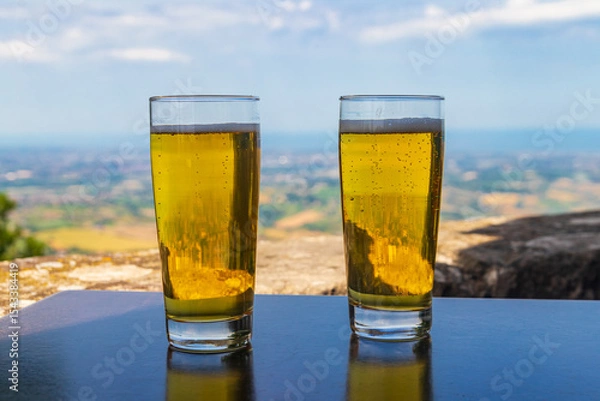 Obraz Two glasses of beer on a table with a view of San Marino