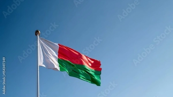 Fototapeta Flag of Madagascar waves proudly in the sky during Independence Day celebration