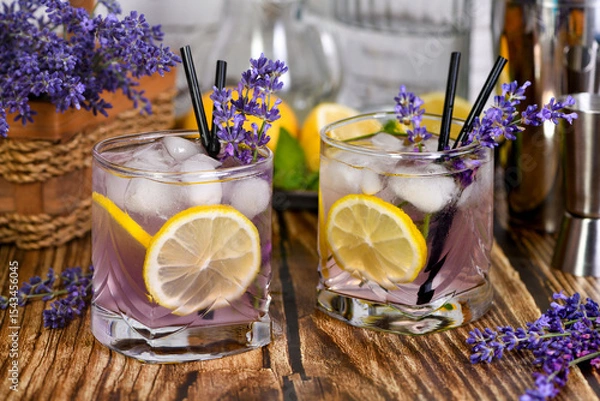 Fototapeta Margarita cocktail with lavender flavor. Garnished with lemon wedges and lavender sprigs