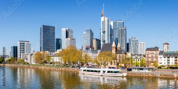 Fototapeta Frankfurt skyline skyscrapers with banks on River Main with excursion boat panorama in Frankfurt, Germany